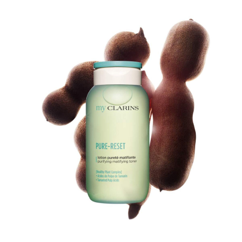 Packshot of a purifying and matifying facial lotion alongside tamarind beans on a light blue background